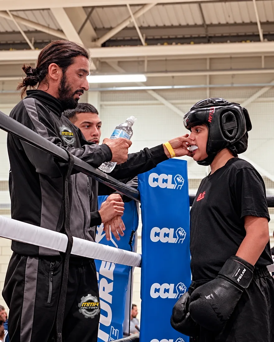 Coach Amar cornering a young fighter between rounds