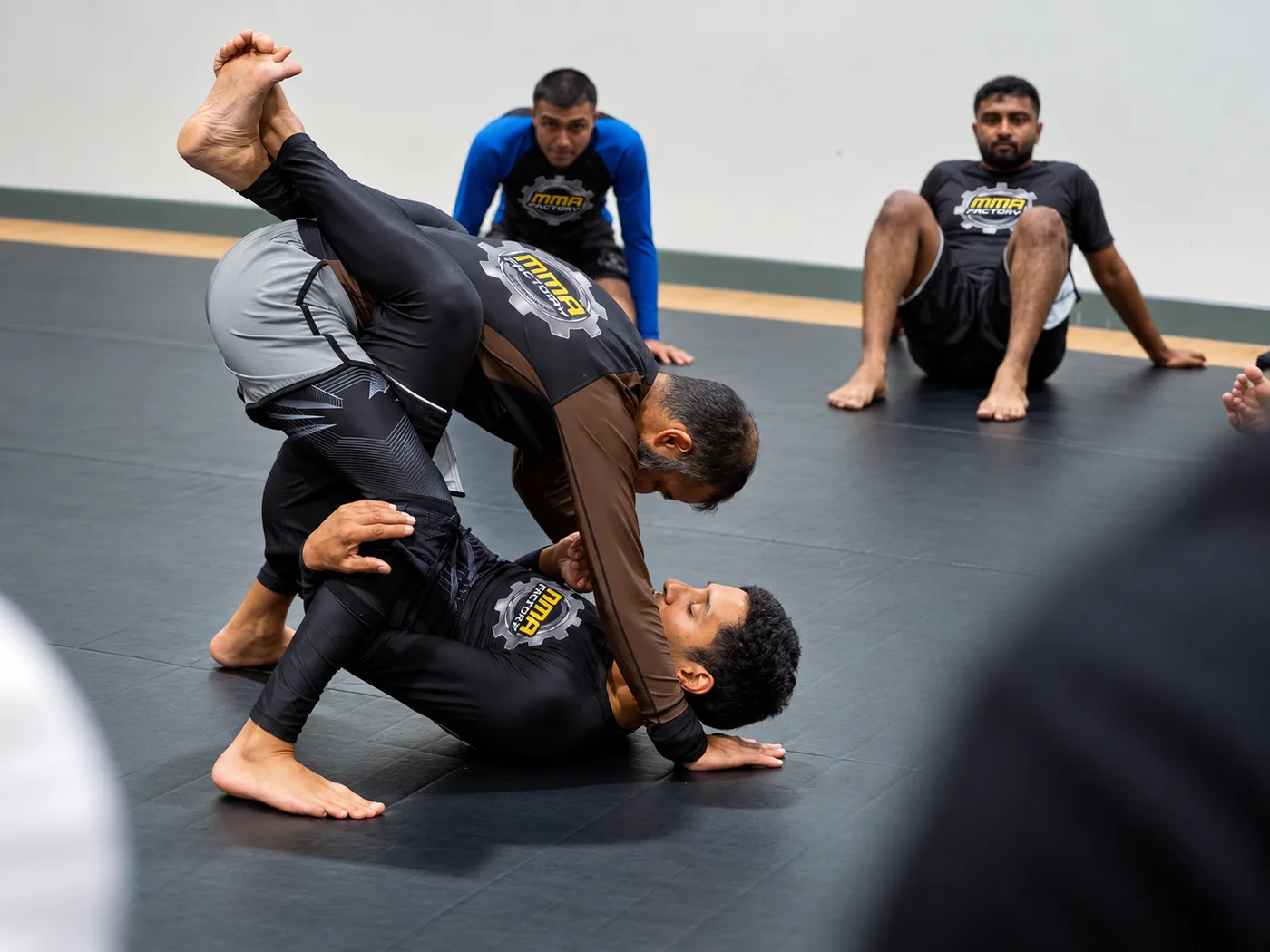 Two MMA Factory members drilling a guard pass in no-gi