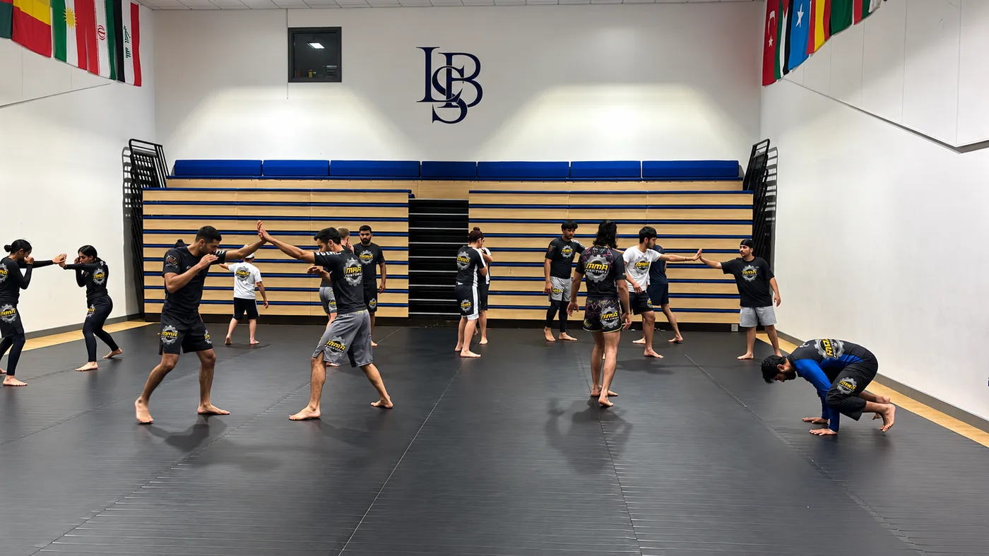 Members drilling striking in pairs across the MMA Factory mats