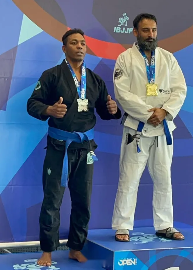 Sarbjeet standing on an IBJJF podium with a gold medal